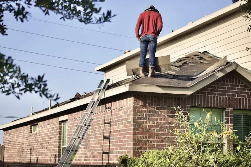 Professional roofer working on a residential roof in Naches